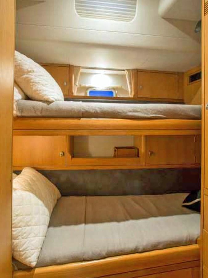 a bed with a white pillow aboard MATAWAI Yacht for Sale