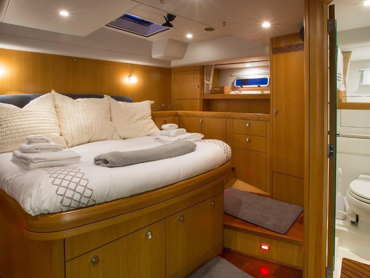 a bedroom with a bed aboard MATAWAI Yacht for Sale