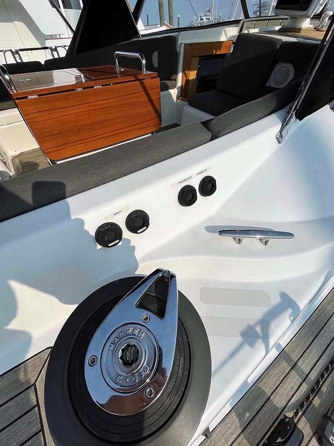 a white car with black wheels aboard MATAWAI Yacht for Sale