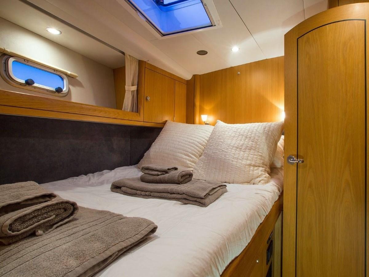 a bed with white sheets aboard MATAWAI Yacht for Sale