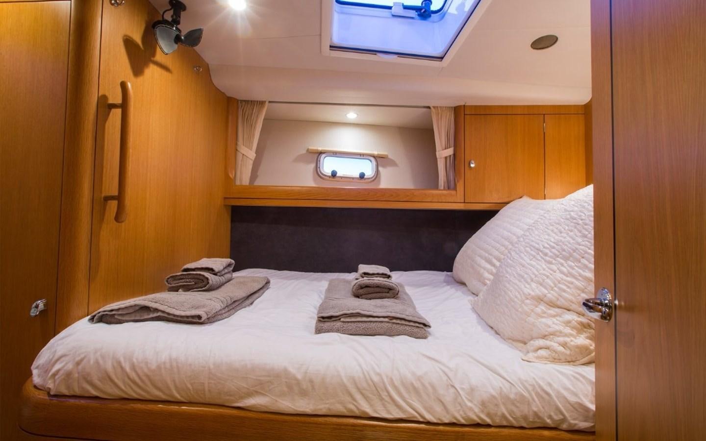 a bed with white sheets aboard MATAWAI Yacht for Sale
