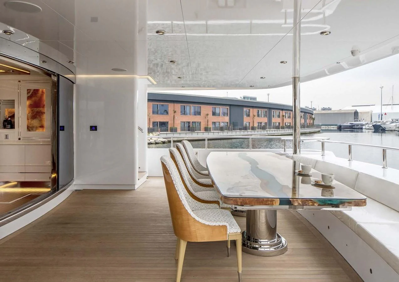 a room with a table and chairs aboard DOMENIKA Yacht for Sale