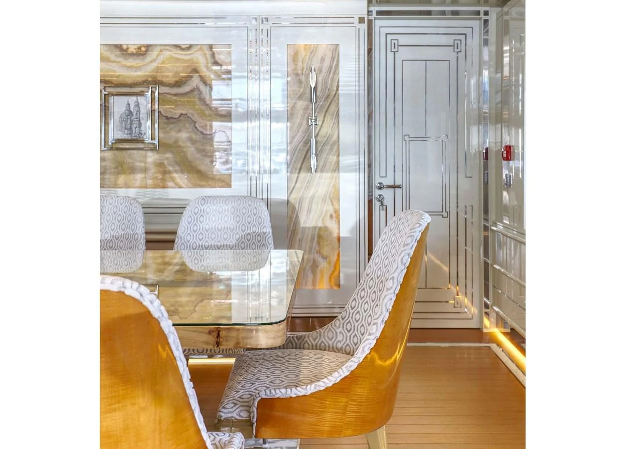 a room with a table and chairs aboard DOMENIKA Yacht for Sale