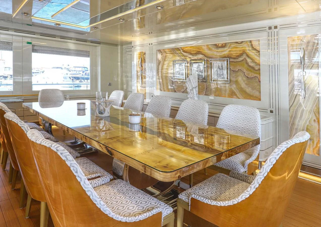 a dining room with chairs and a table aboard DOMENIKA Yacht for Sale