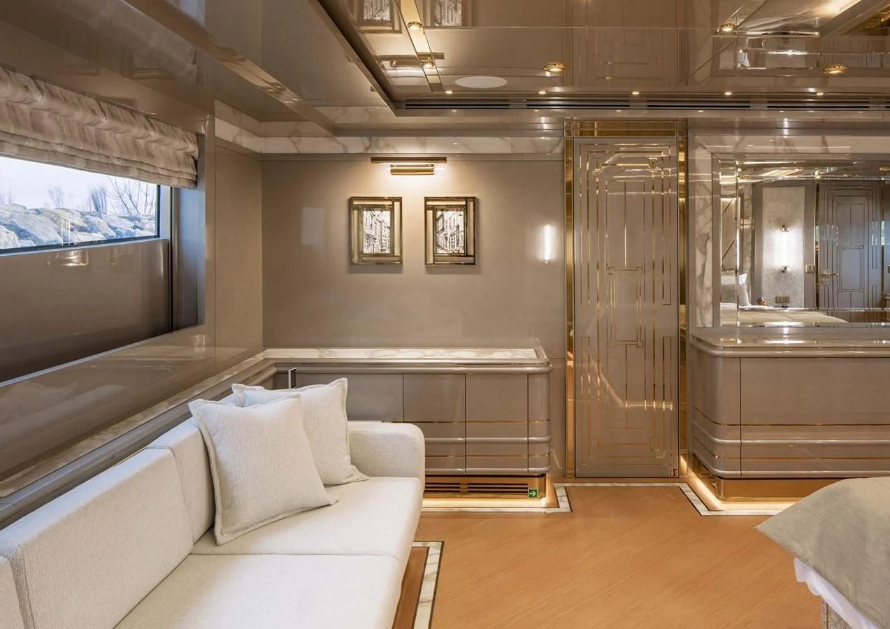 a room with a couch and a bed aboard DOMENIKA Yacht for Sale