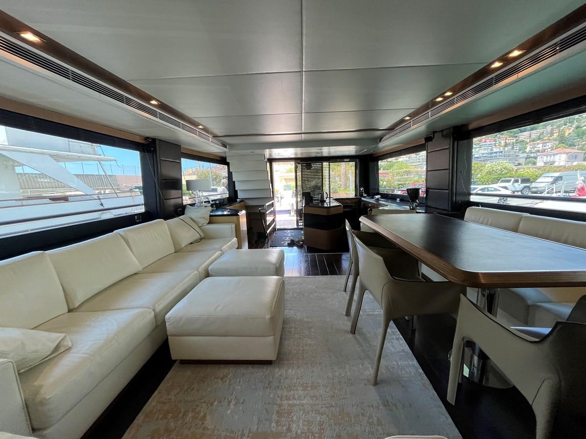 a room with a table and couches aboard CHARISMA II Yacht for Sale