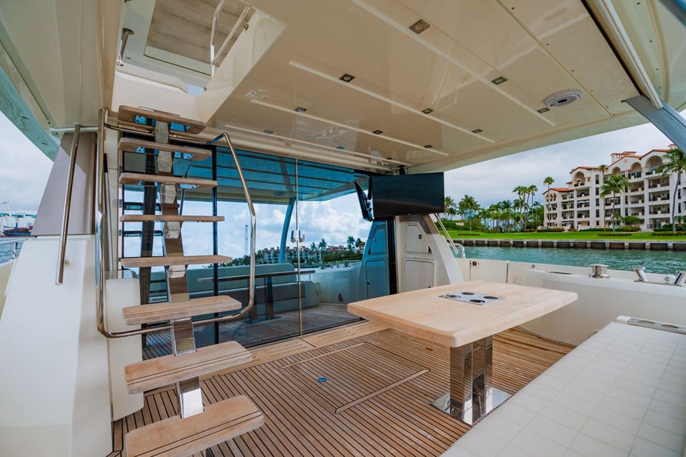 a room with a table and chairs aboard YACHTOOMA Yacht for Sale
