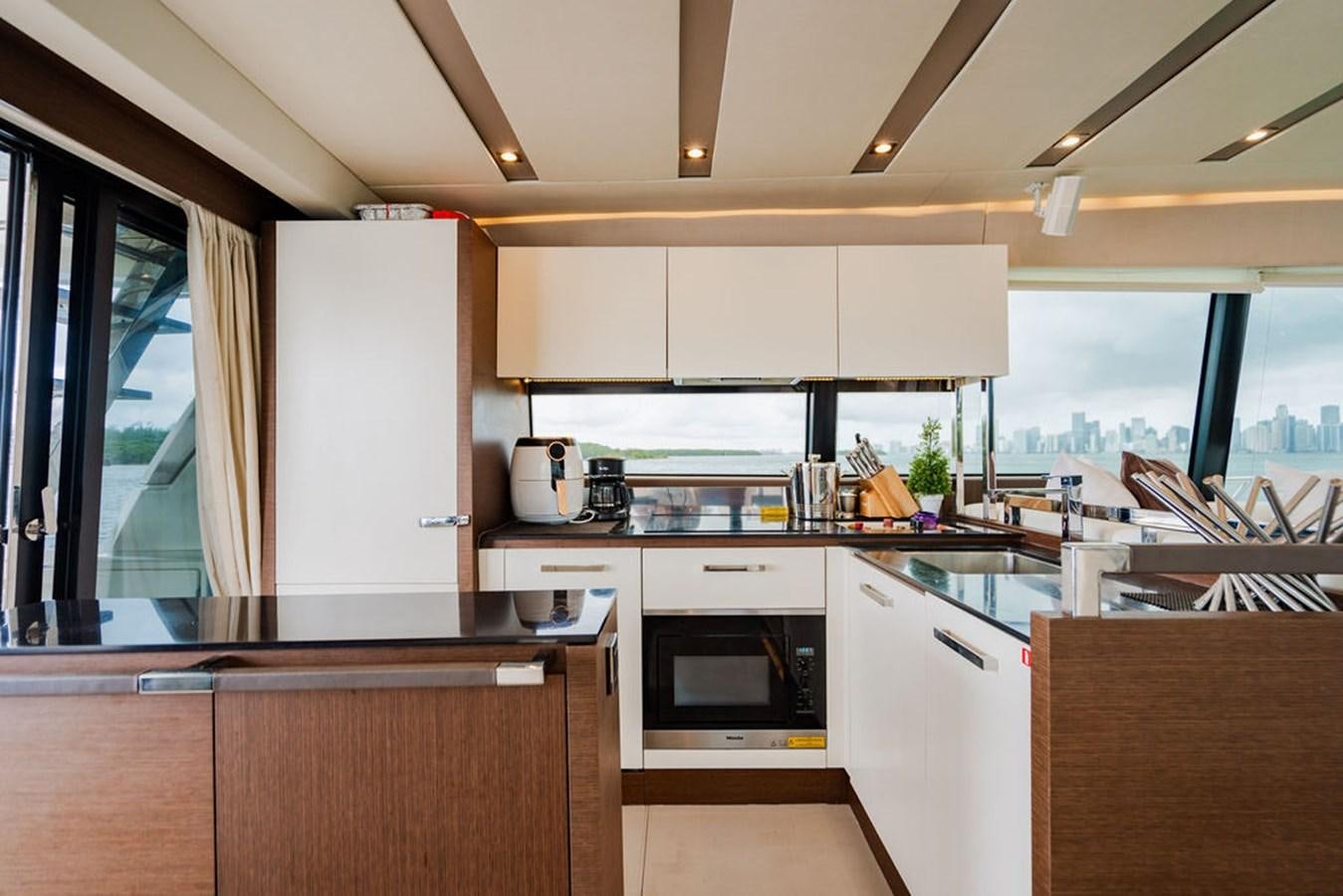 a kitchen with white cabinets aboard YACHTOOMA Yacht for Sale