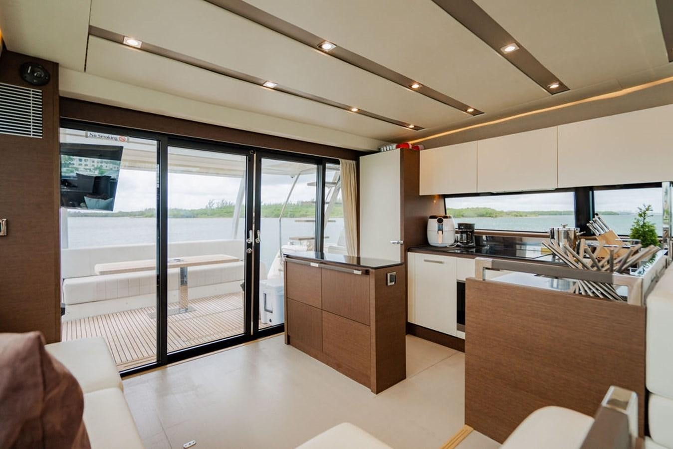a kitchen with a sliding glass door aboard YACHTOOMA Yacht for Sale