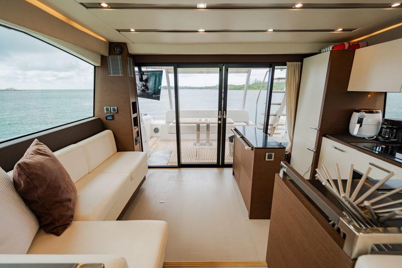a room with a couch and a view of the water aboard YACHTOOMA Yacht for Sale