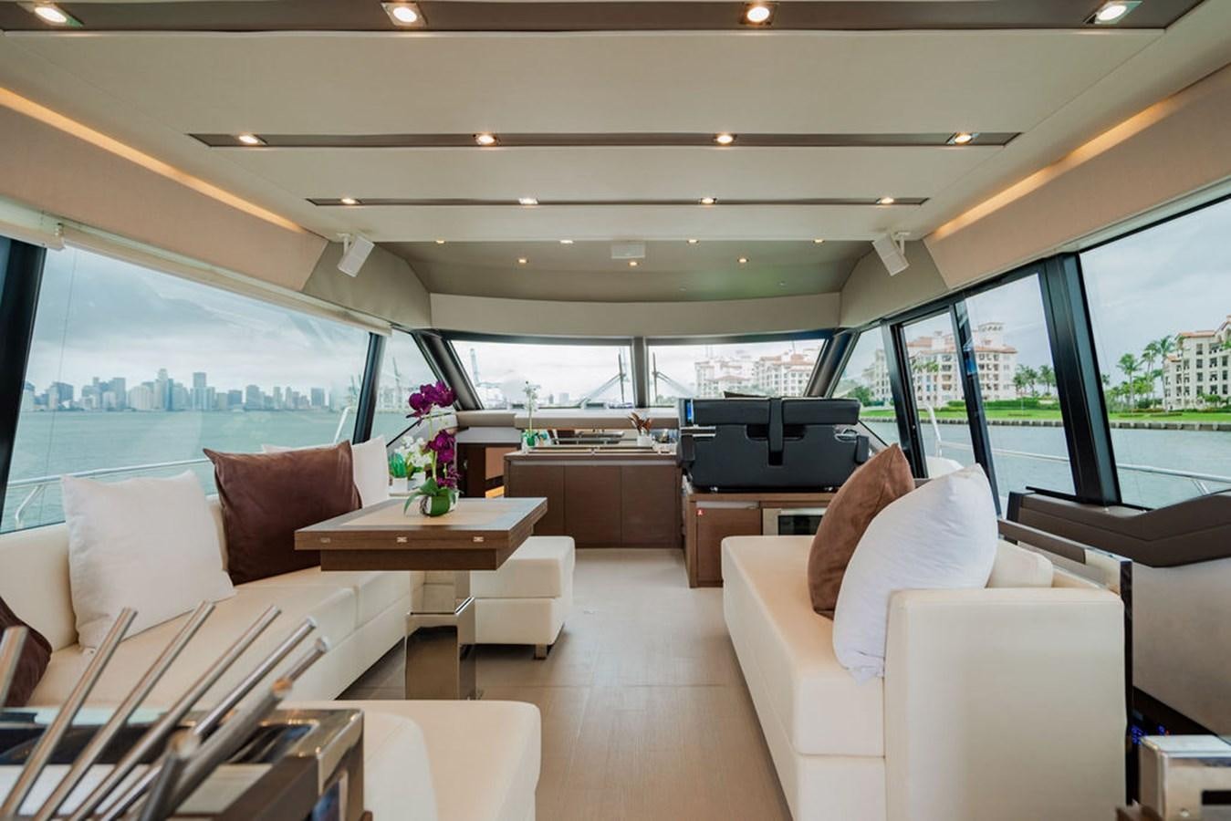 a room with a couch and a table and a television aboard YACHTOOMA Yacht for Sale