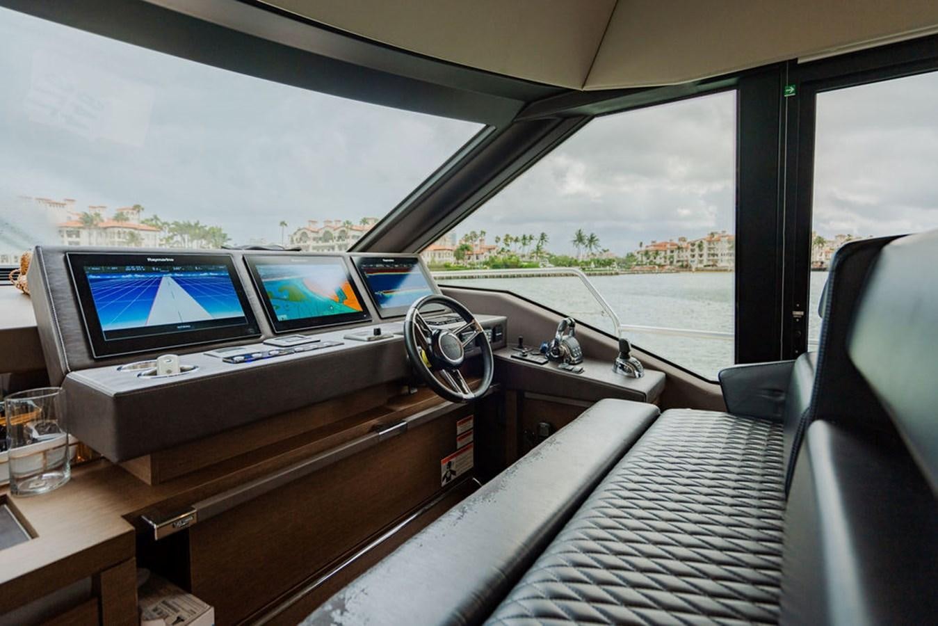 a car with a couple of laptops on the dashboard aboard YACHTOOMA Yacht for Sale