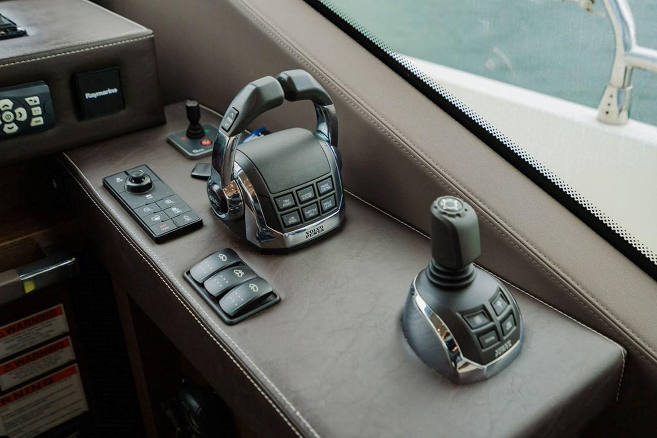 a couple of phones on a table aboard YACHTOOMA Yacht for Sale