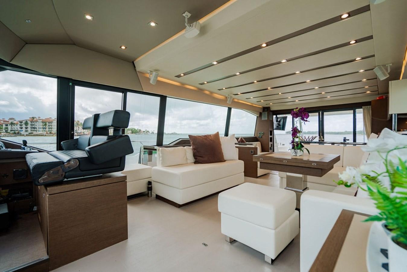 a living room with a large window aboard YACHTOOMA Yacht for Sale