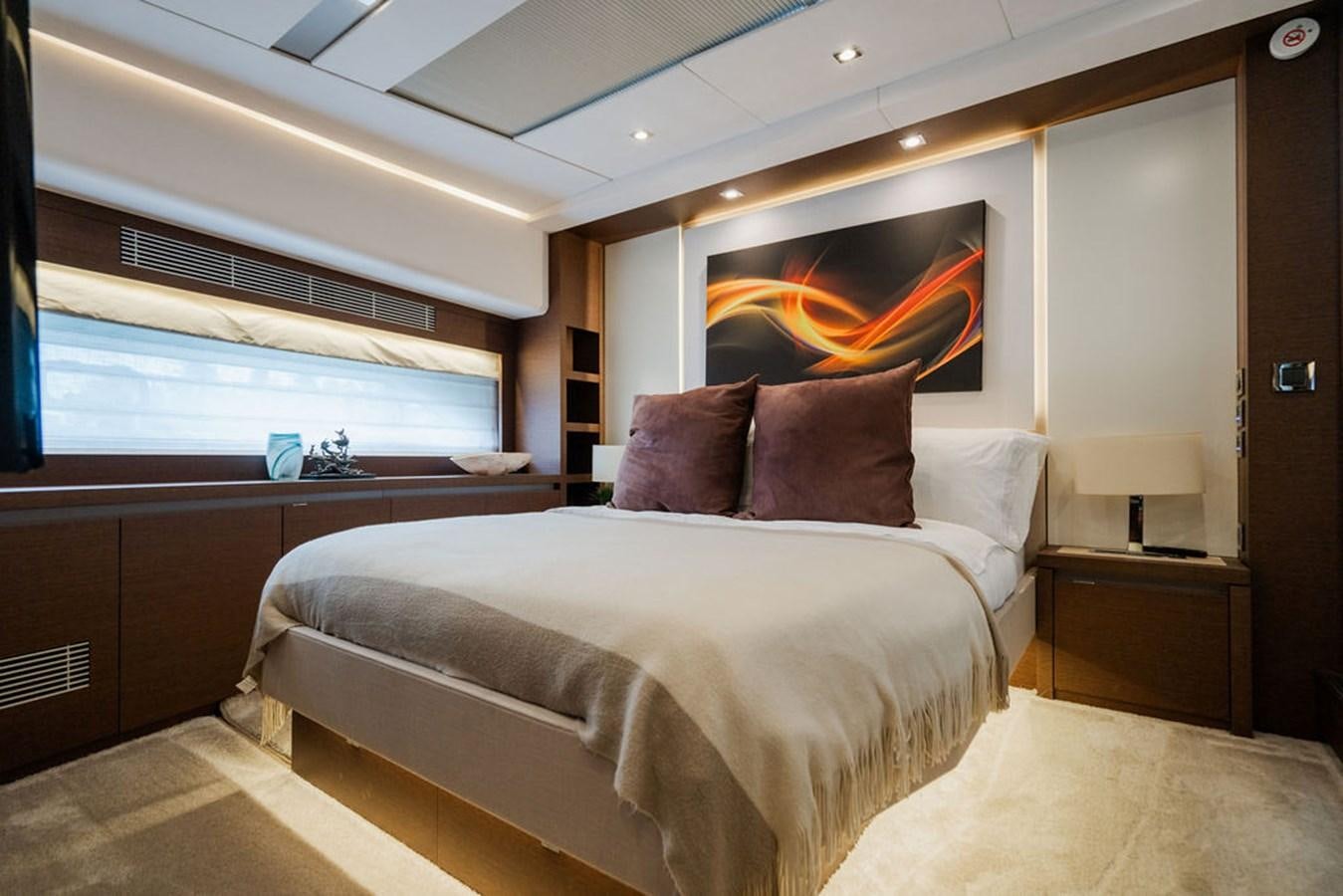 a room with a bed and a television aboard YACHTOOMA Yacht for Sale
