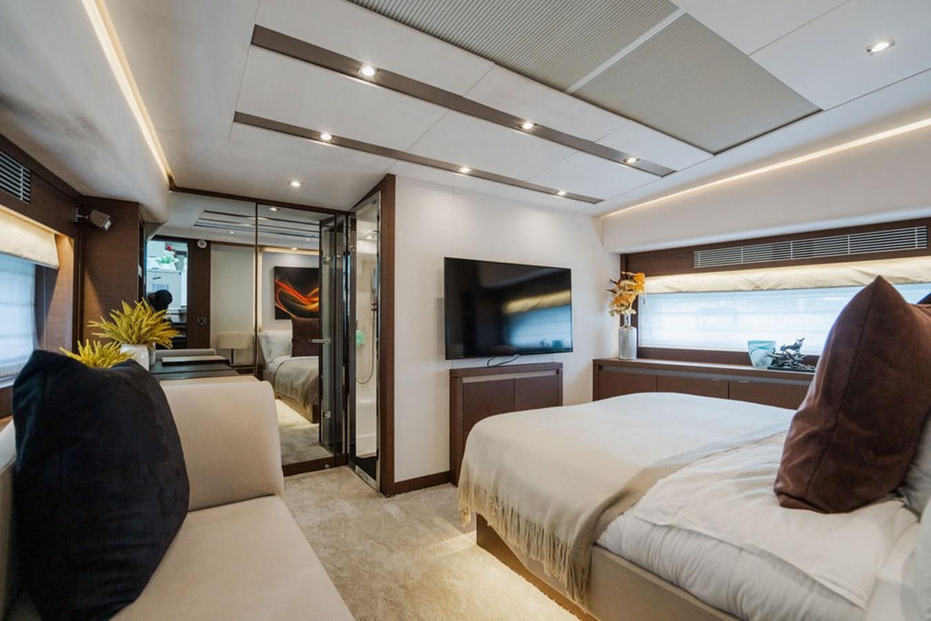 a bedroom with a bed and a tv aboard YACHTOOMA Yacht for Sale