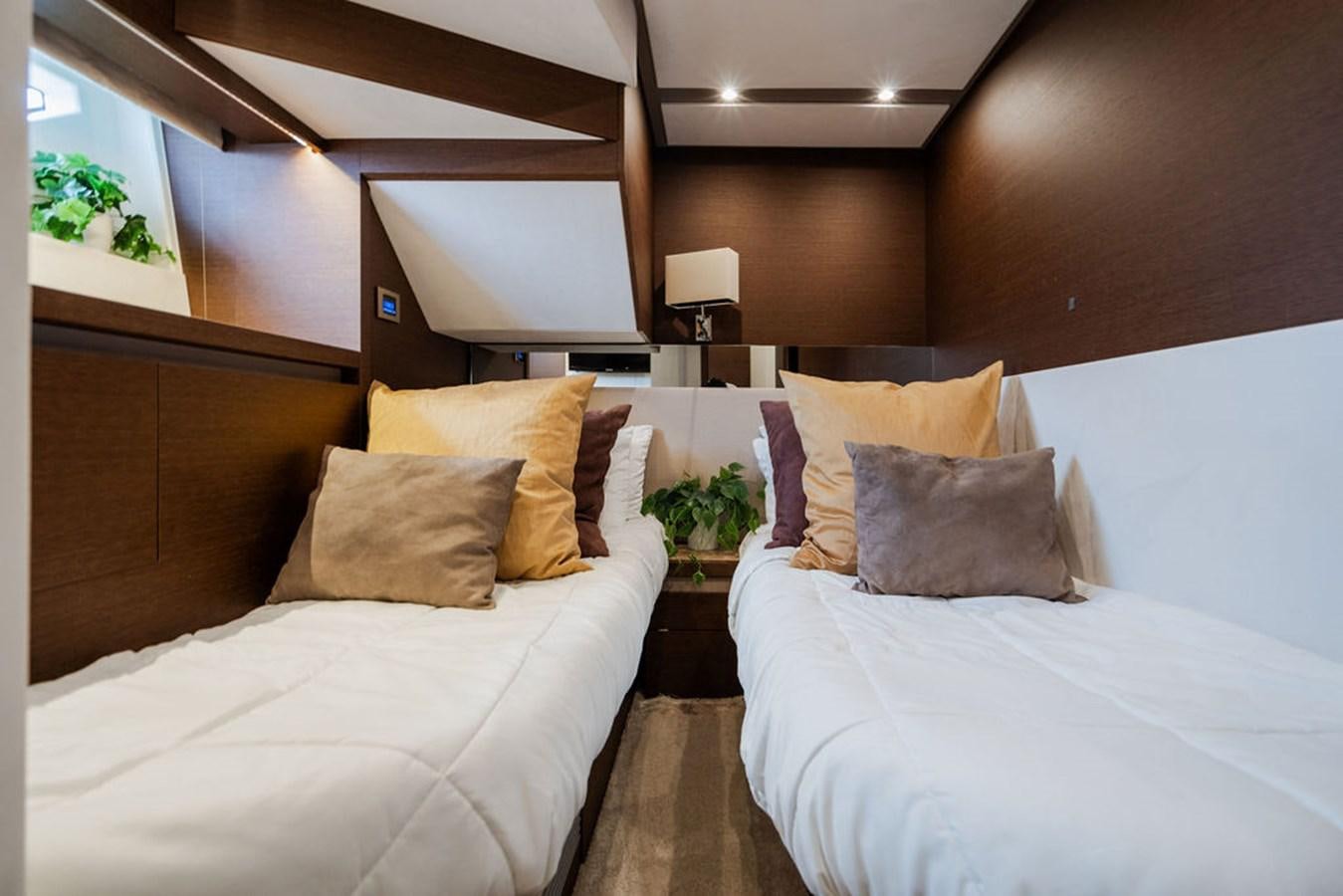 a room with two beds aboard YACHTOOMA Yacht for Sale