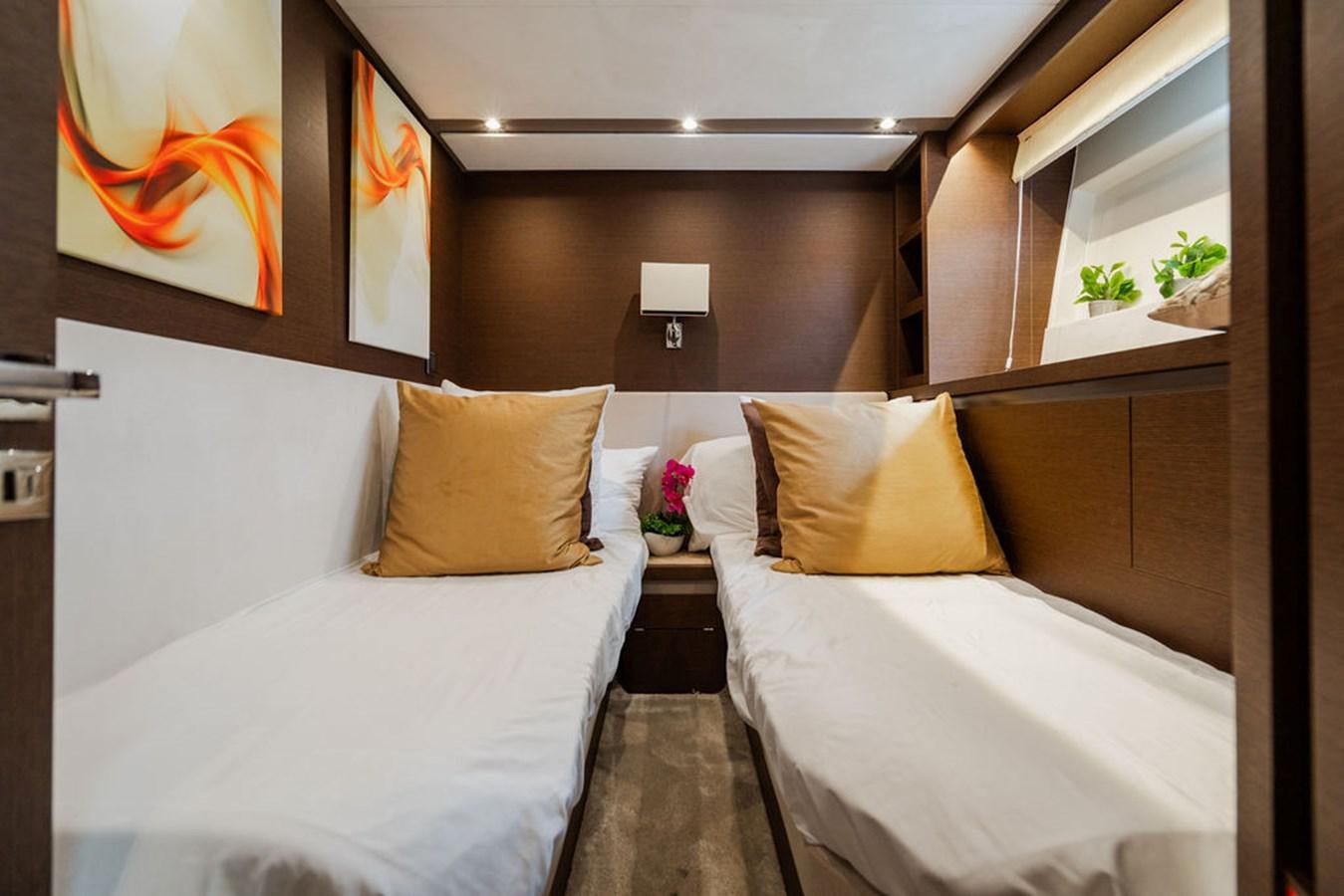 a room with two beds aboard YACHTOOMA Yacht for Sale