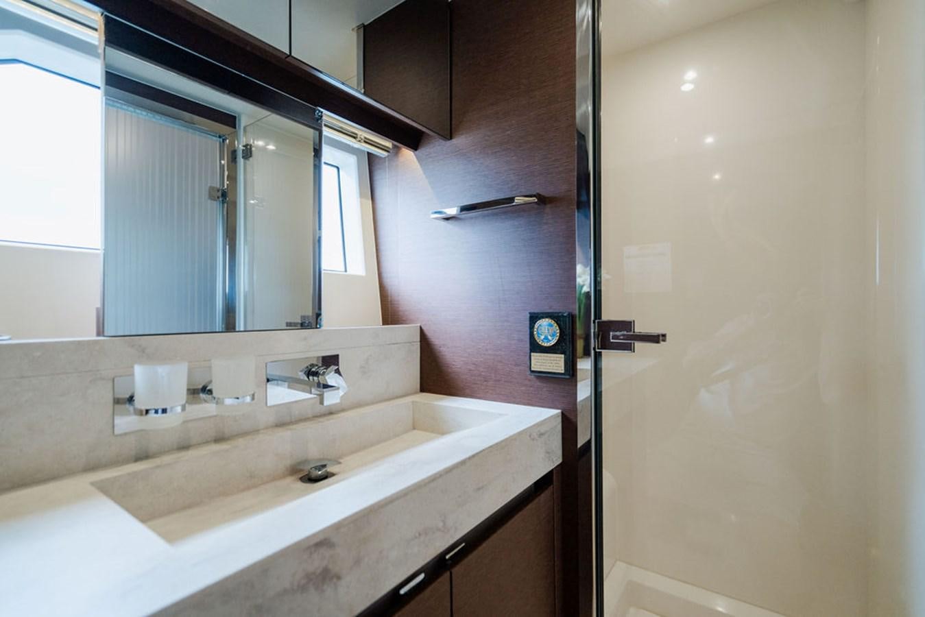 a bathroom with a sink and a mirror aboard YACHTOOMA Yacht for Sale