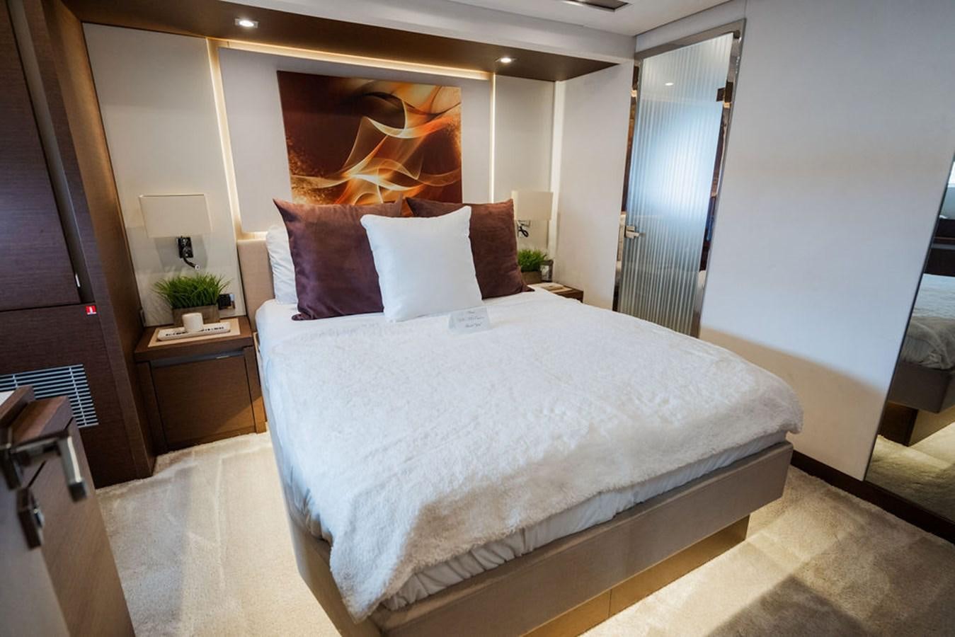 a bed with a white sheet and pillows aboard YACHTOOMA Yacht for Sale