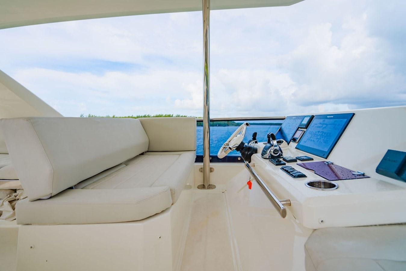 a room with a couch and a laptop on a table aboard YACHTOOMA Yacht for Sale