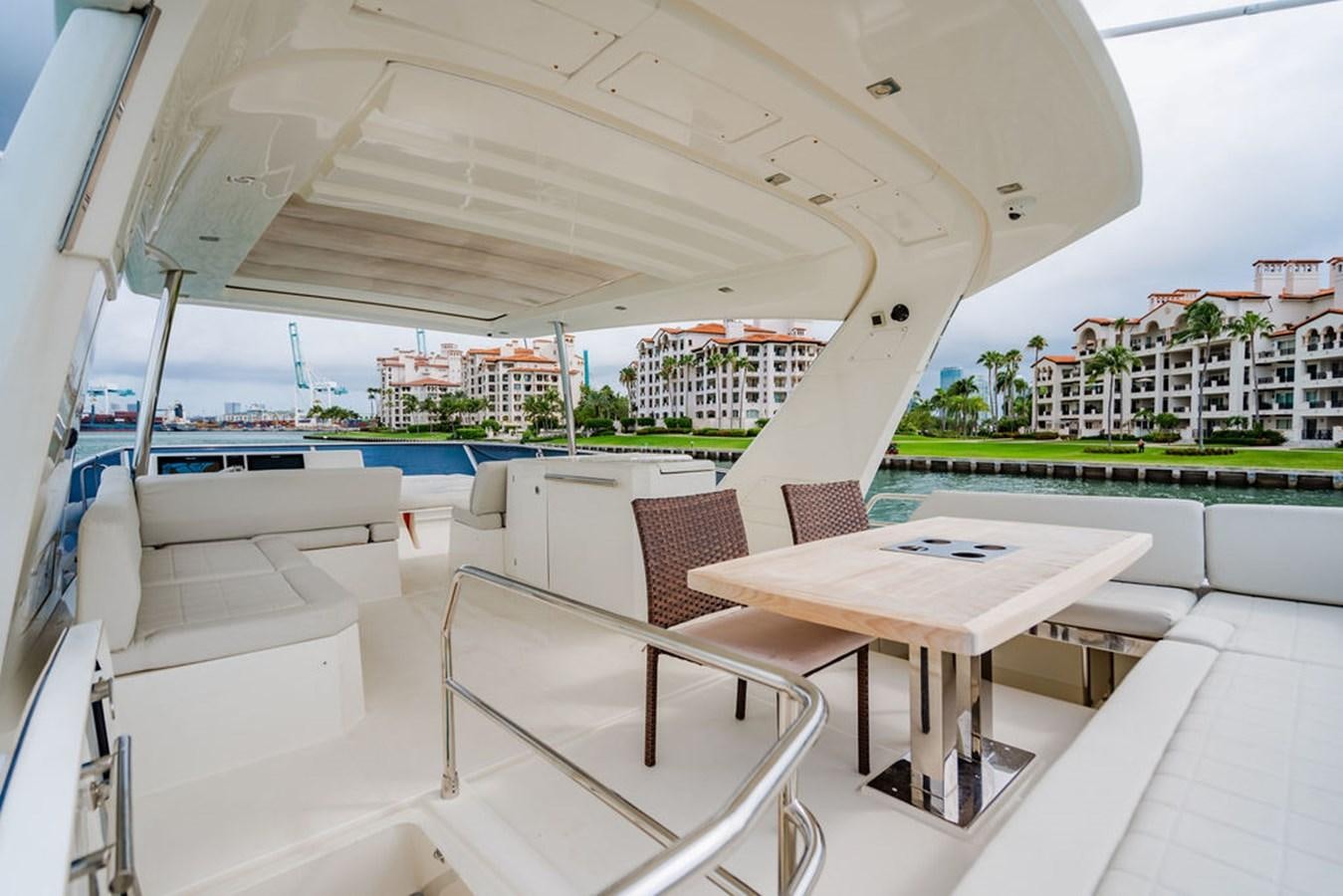 a table and chairs on a patio aboard YACHTOOMA Yacht for Sale