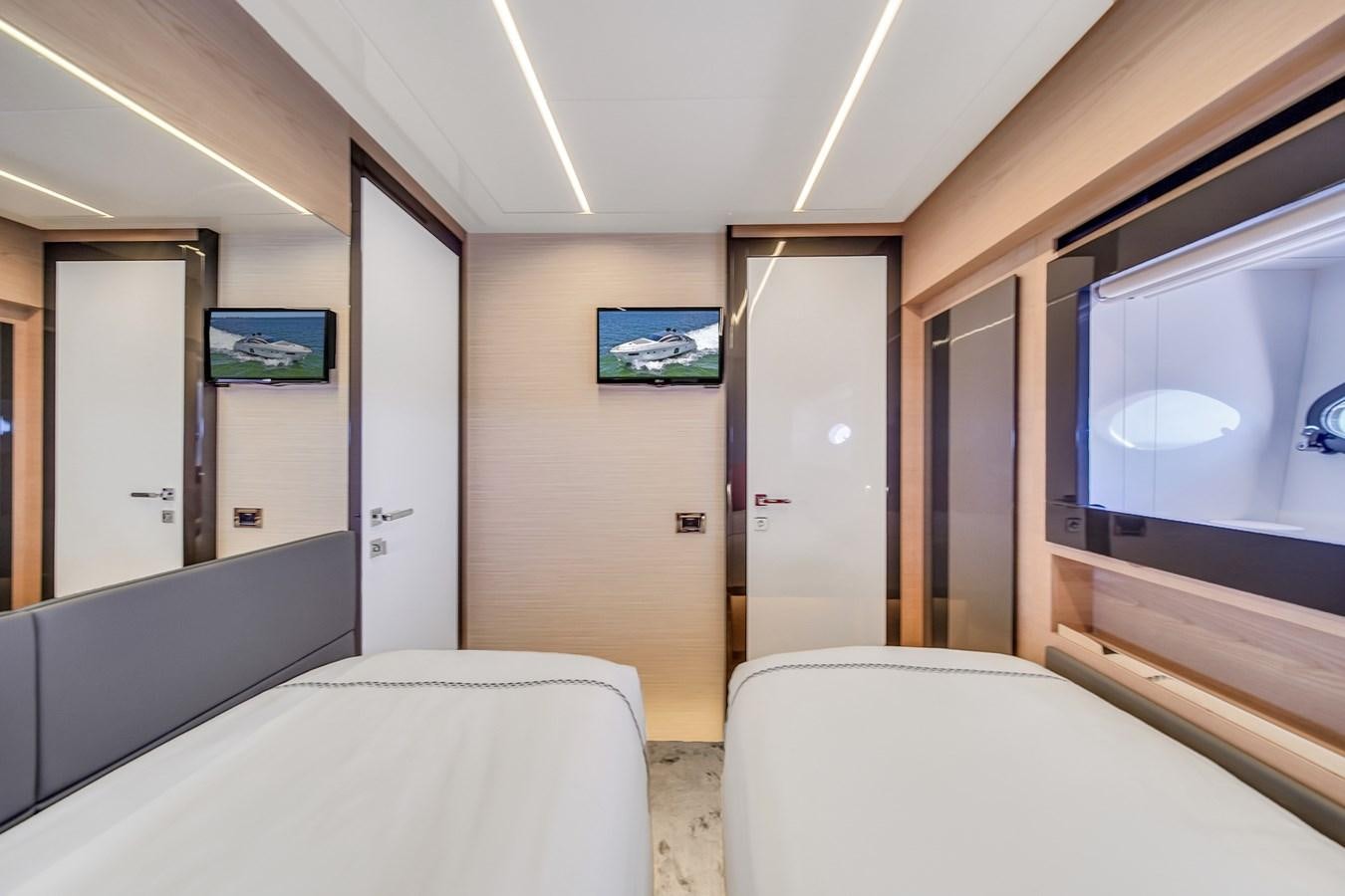 a room with beds and a tv aboard SANS SOUCI VIII Yacht for Sale