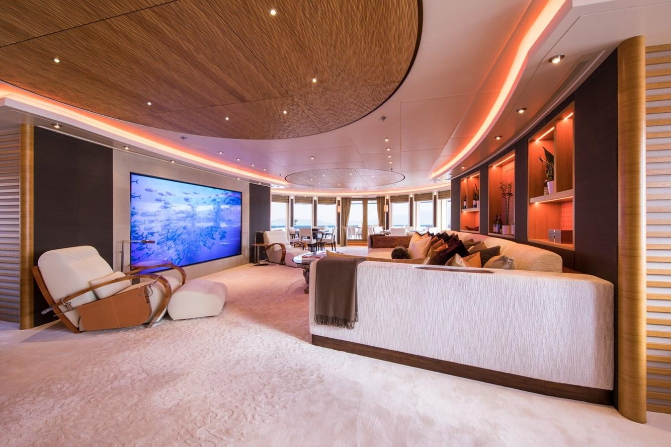 a large living room with a large screen aboard CAIPIRINHA Yacht for Sale