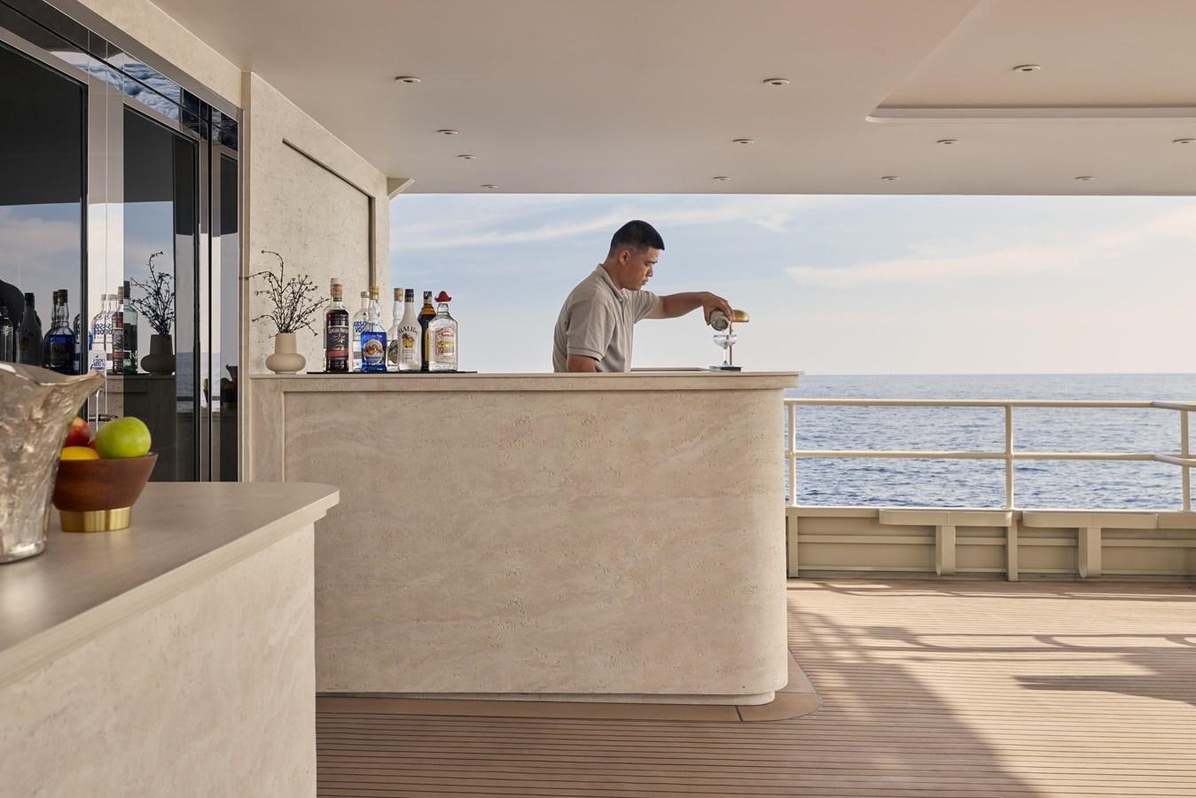 a man standing at a counter aboard VANORA Yacht for Sale