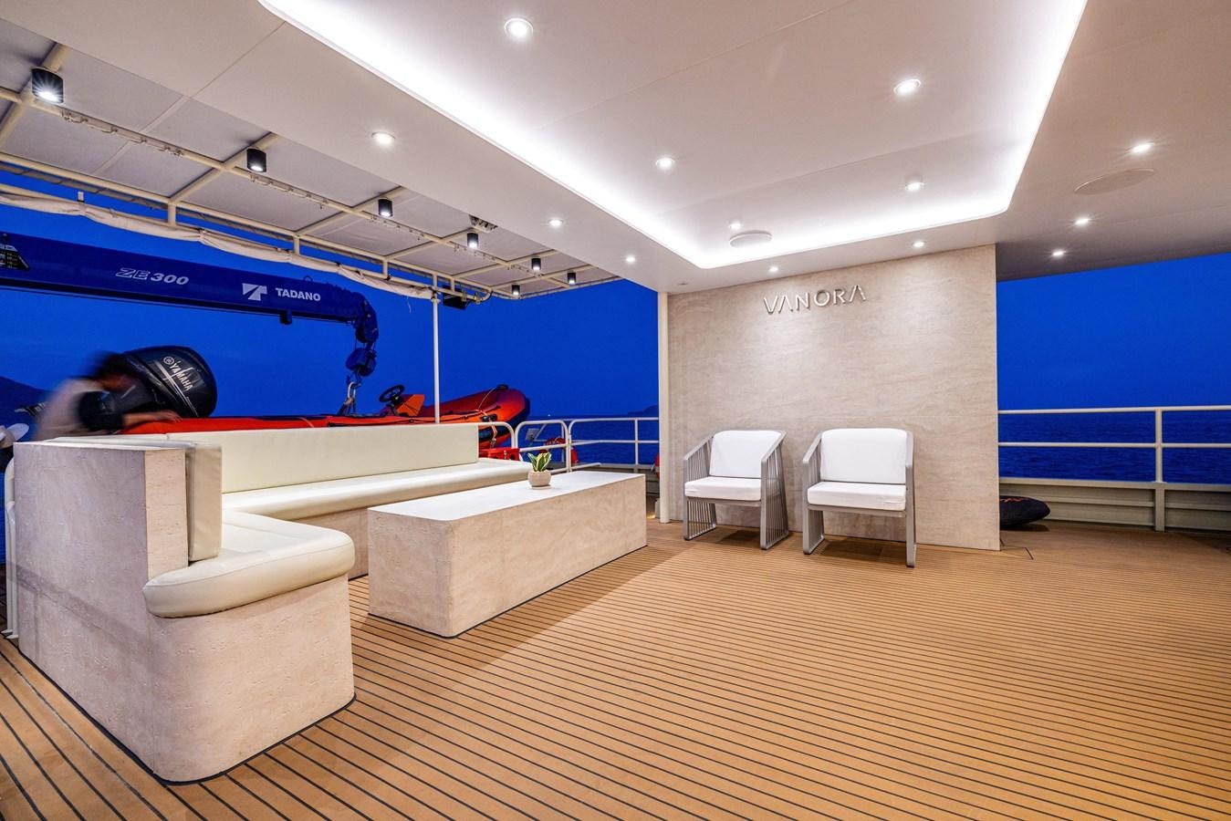 a room with a couch and a chair and a table aboard VANORA Yacht for Sale