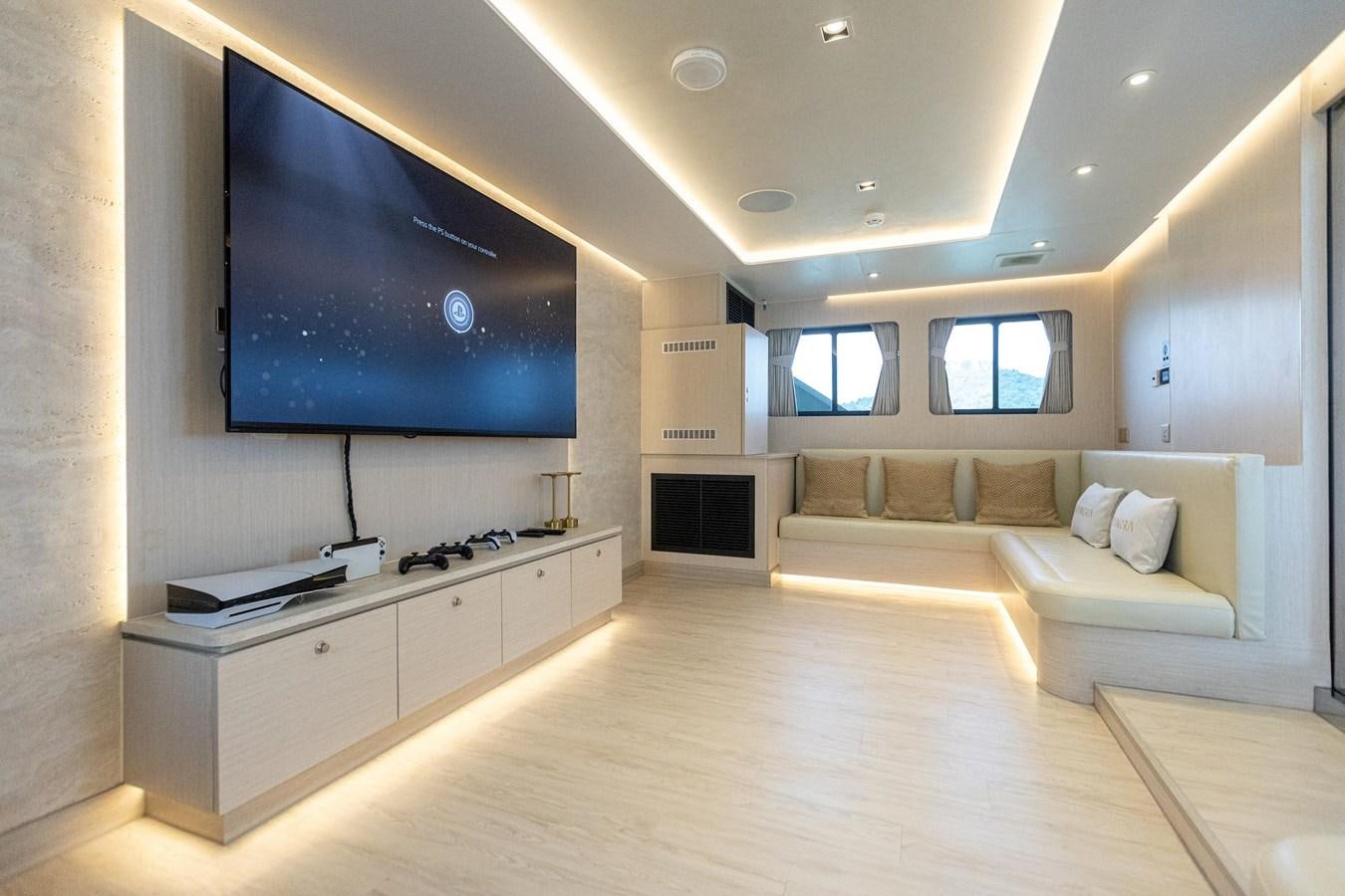 a living room with a couch and a tv aboard VANORA Yacht for Sale