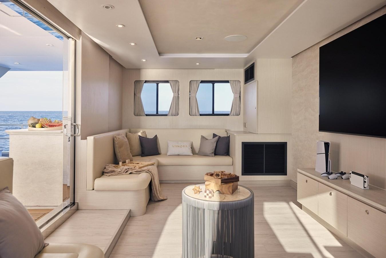 a living room with a couch and a tv aboard VANORA Yacht for Sale