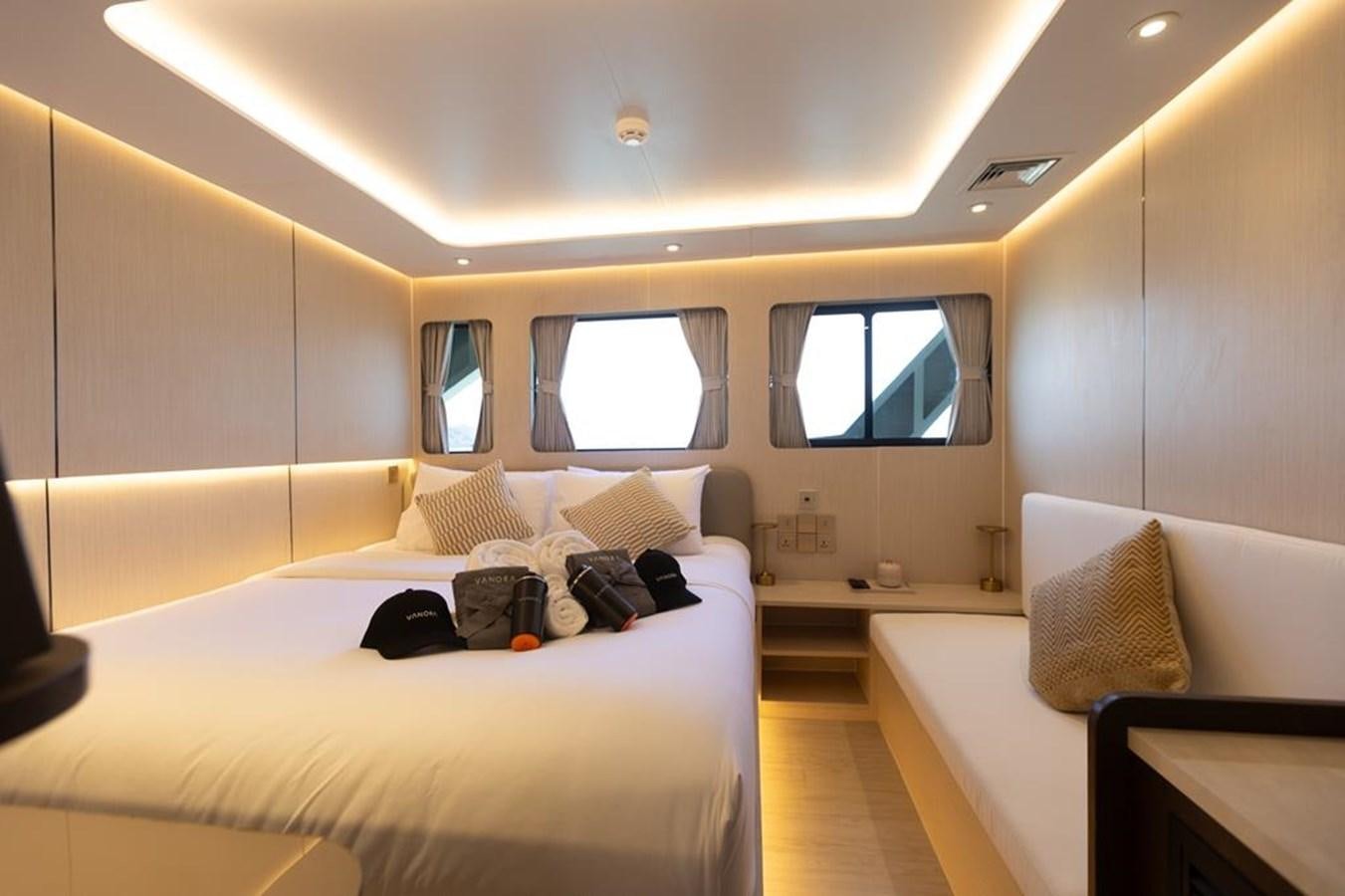 a room with a bed and a window aboard VANORA Yacht for Sale