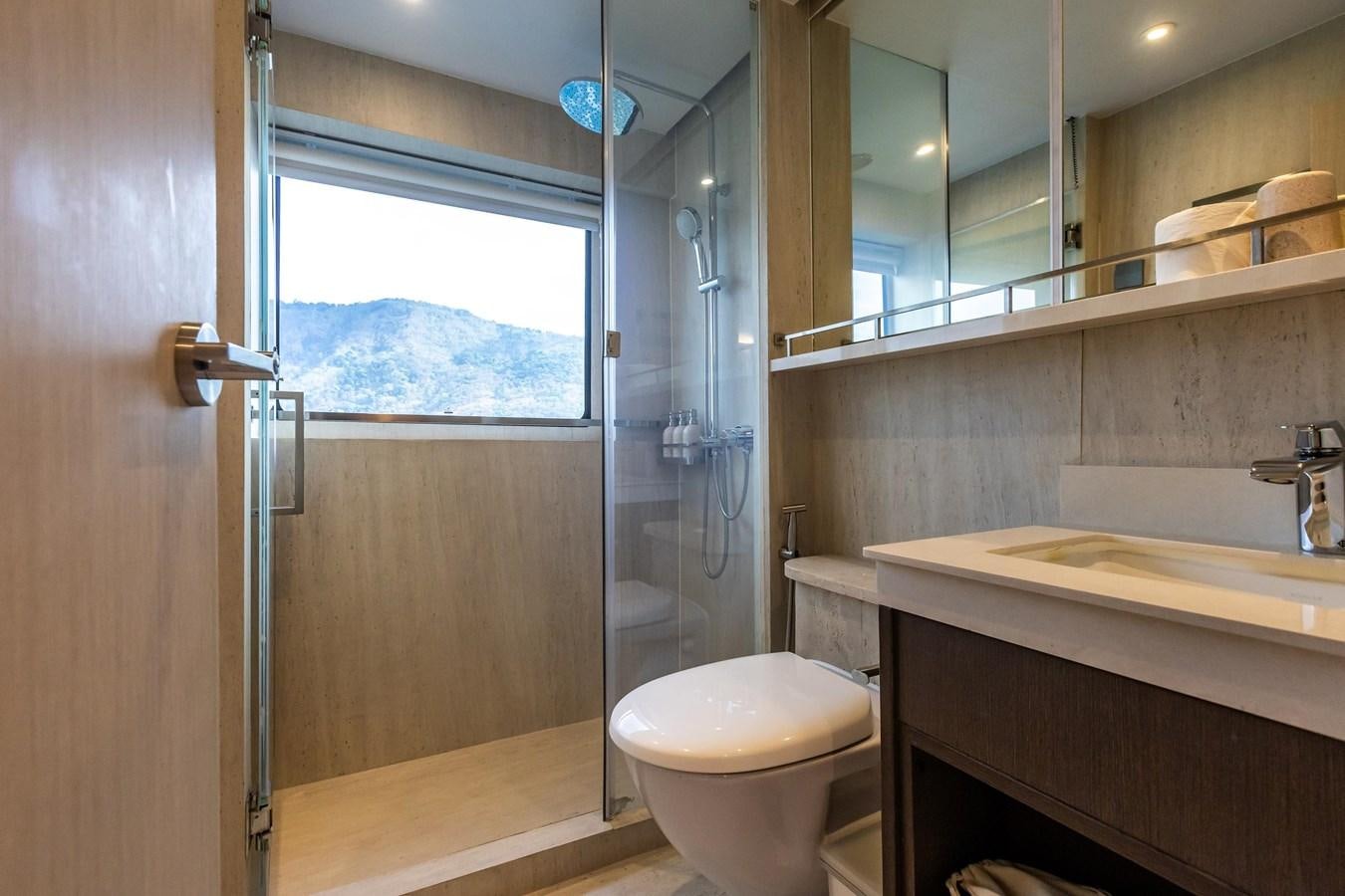 a bathroom with a glass shower door aboard VANORA Yacht for Sale