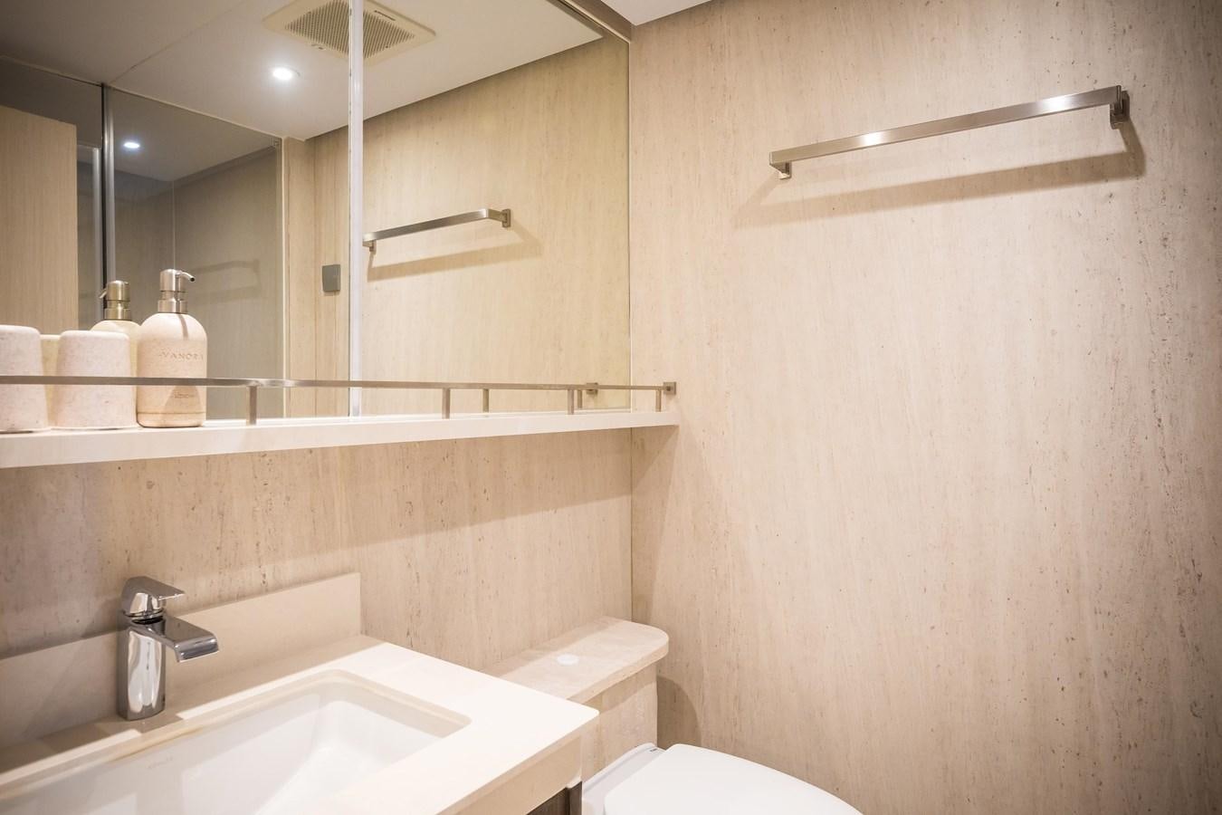 a bathroom with a toilet and sink aboard VANORA Yacht for Sale