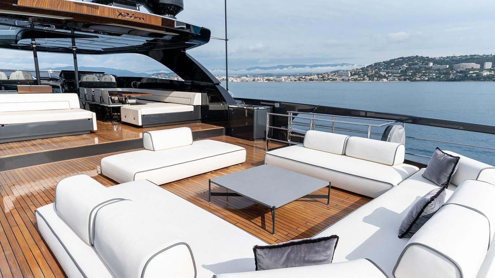 a room with a couch and a table and a large window aboard LADY FIRST Yacht for Sale