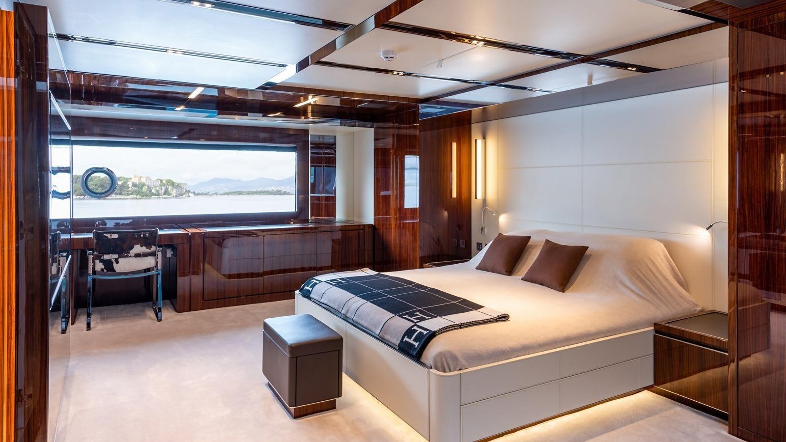 a room with a bed and a table aboard LADY FIRST Yacht for Sale