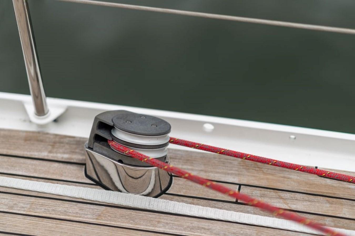 a silver and red headphones on a wooden surface aboard ECOVER OF SKAGEN Yacht for Sale
