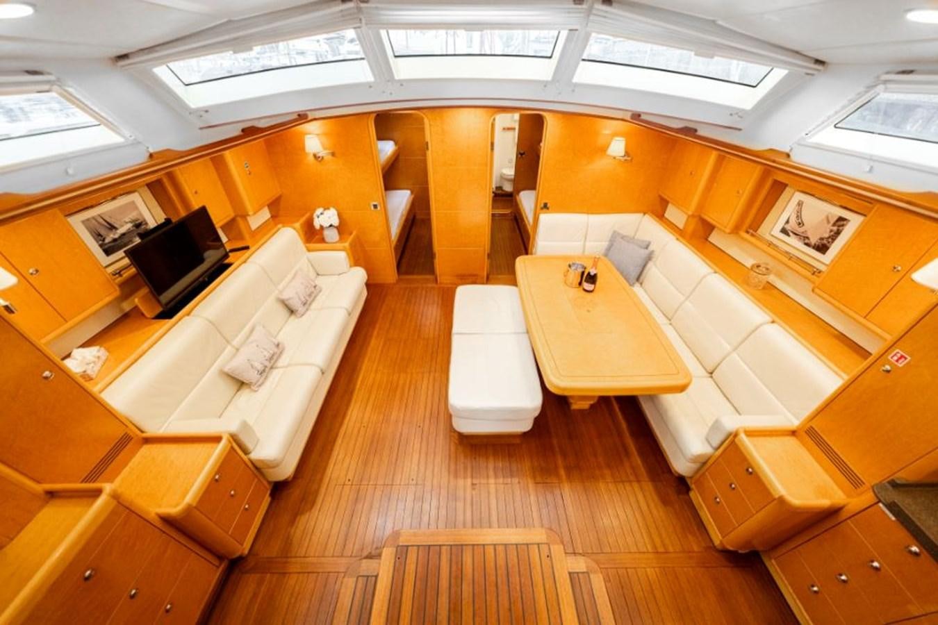 a room with a table and chairs aboard ECOVER OF SKAGEN Yacht for Sale