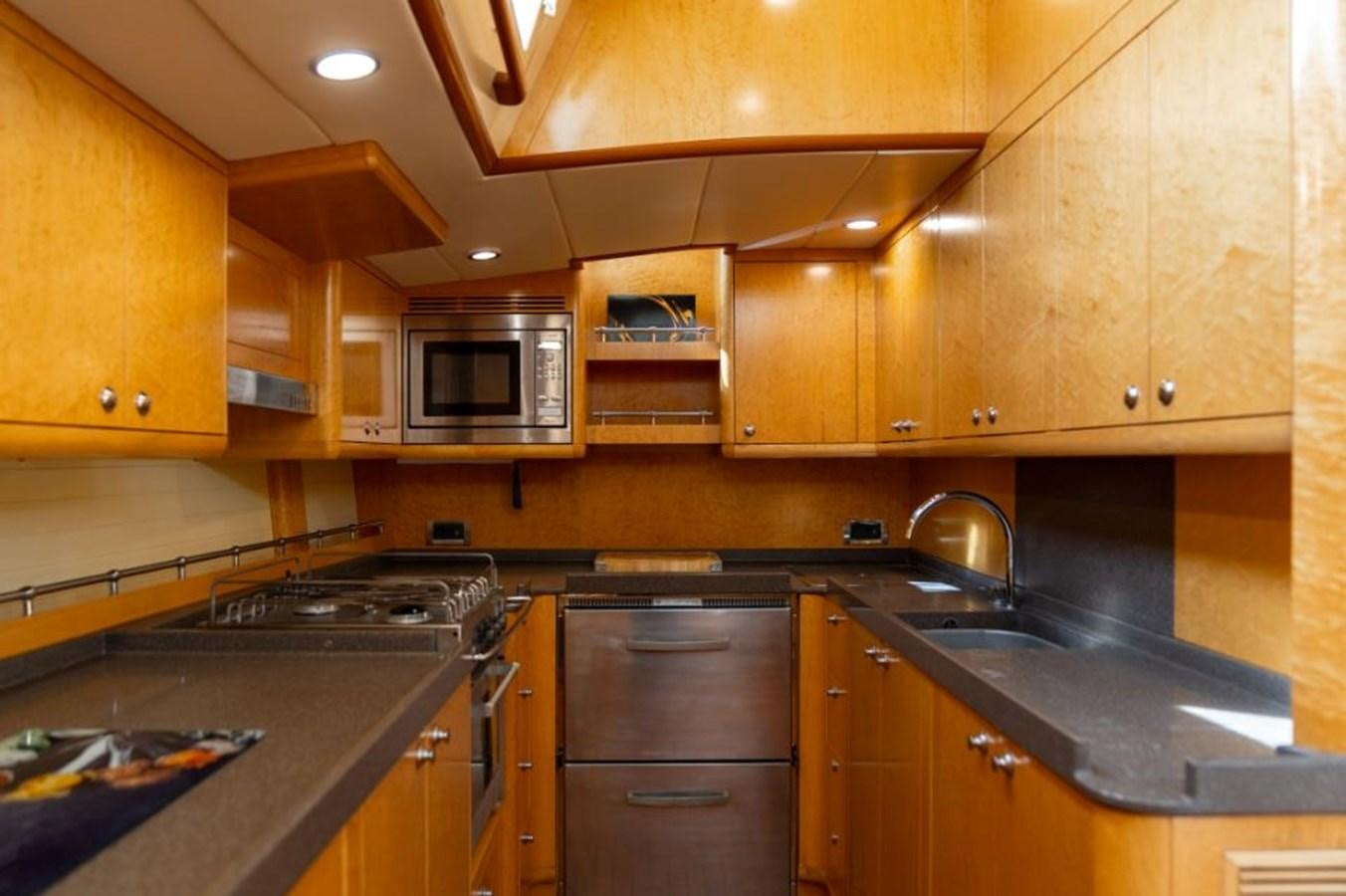 a kitchen with wooden cabinets aboard ECOVER OF SKAGEN Yacht for Sale