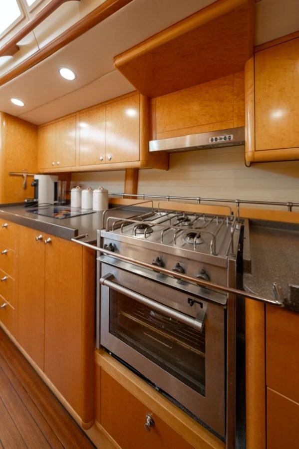 a kitchen with wooden cabinets aboard ECOVER OF SKAGEN Yacht for Sale