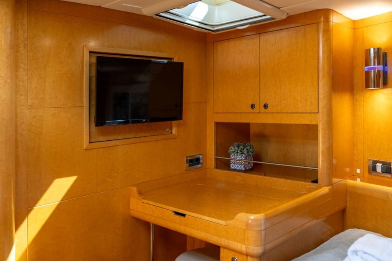 a room with a television and a table aboard ECOVER OF SKAGEN Yacht for Sale