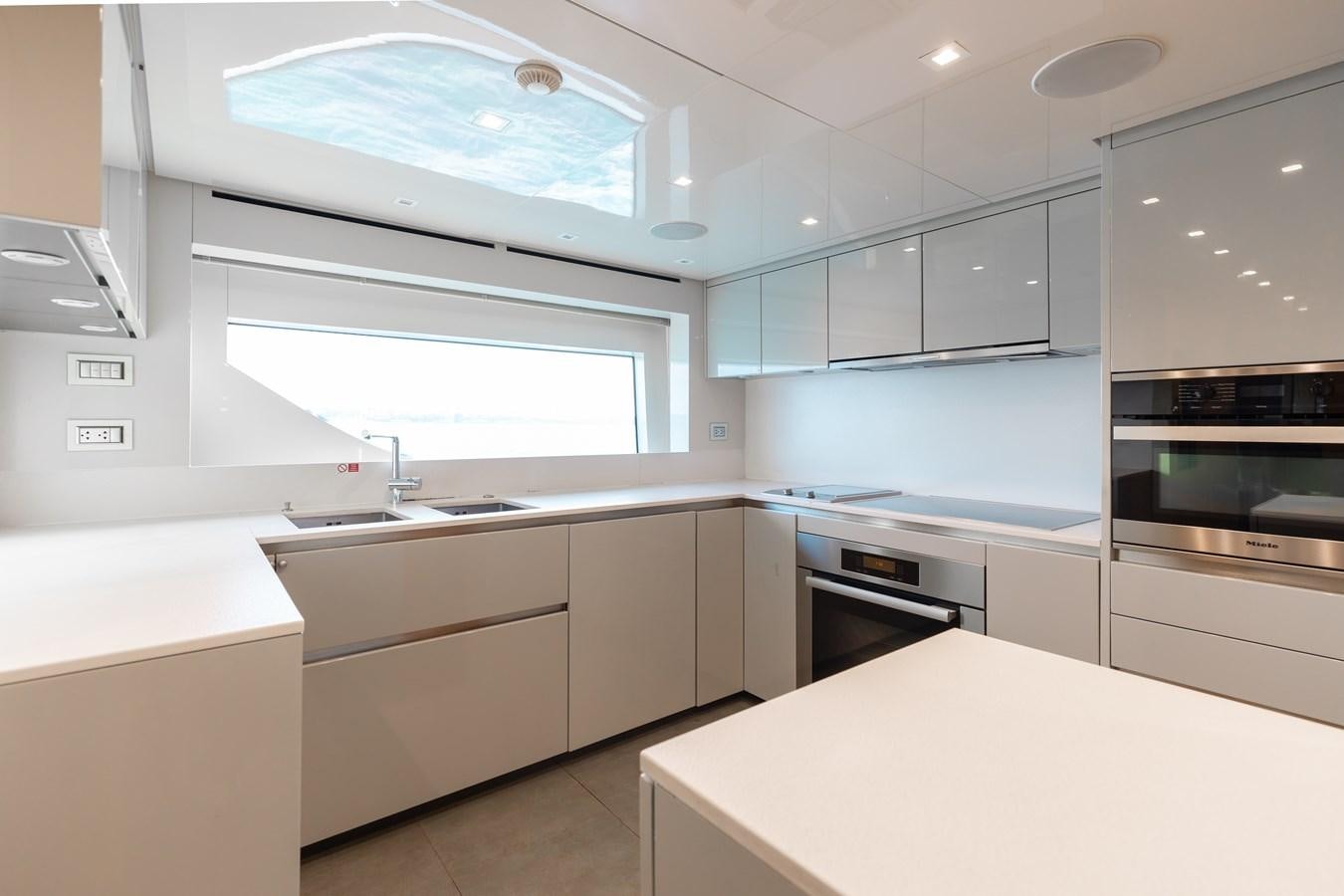 a kitchen with white cabinets aboard TAKARA ONE Yacht for Sale