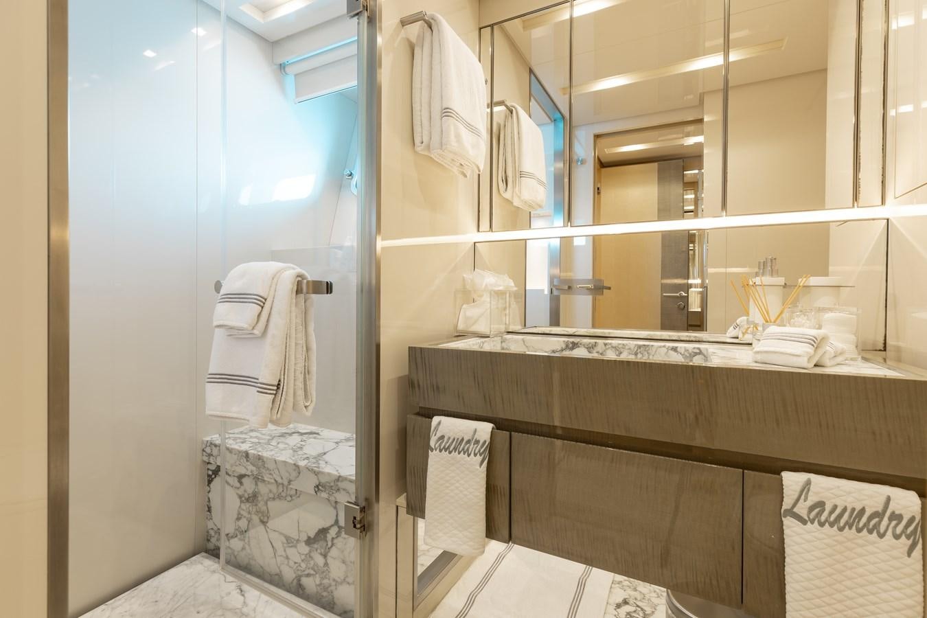a bathroom with a glass shower aboard TAKARA ONE Yacht for Sale