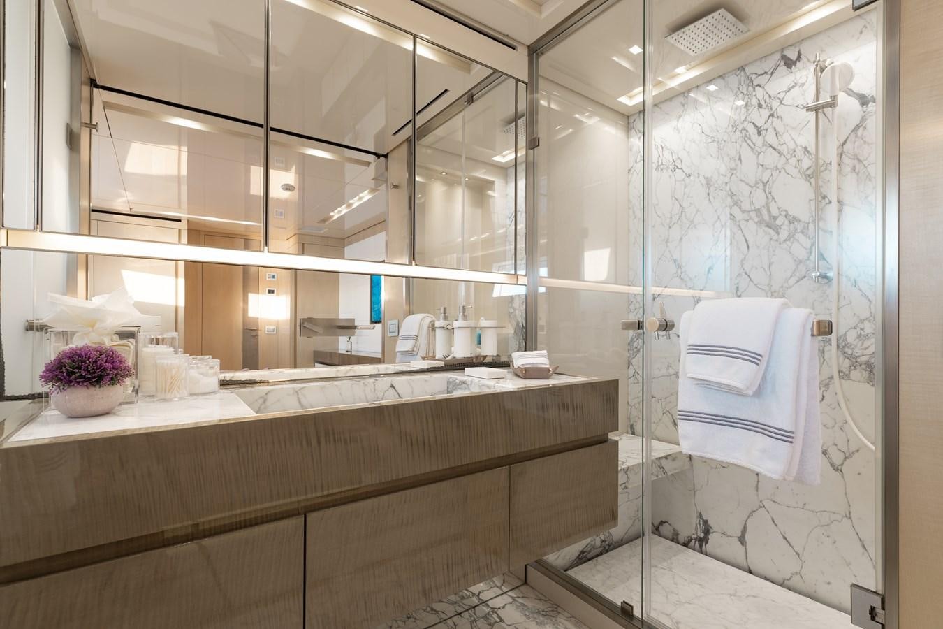 a bathroom with a glass shower aboard TAKARA ONE Yacht for Sale
