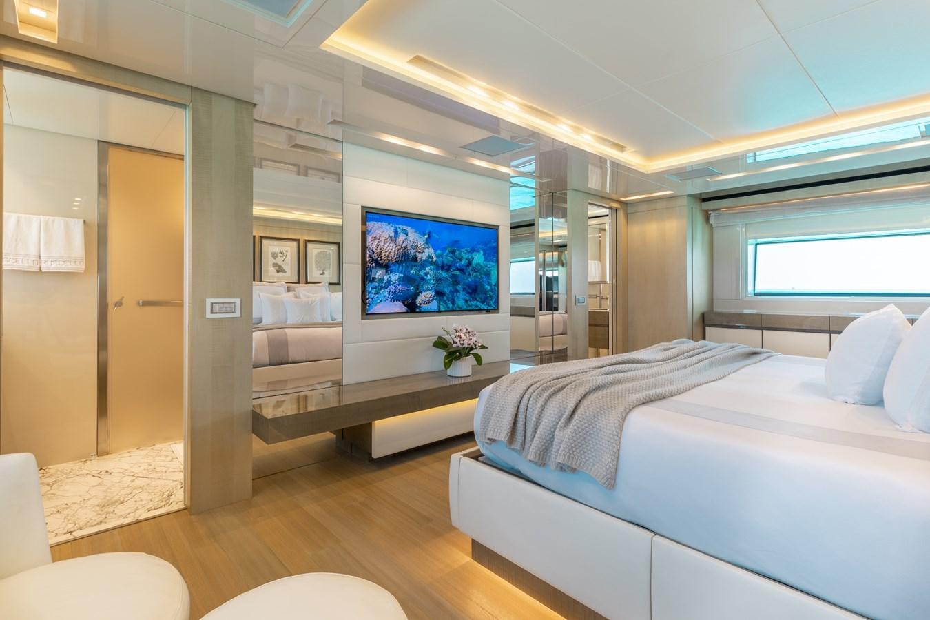 a room with a bed and a tv aboard TAKARA ONE Yacht for Sale