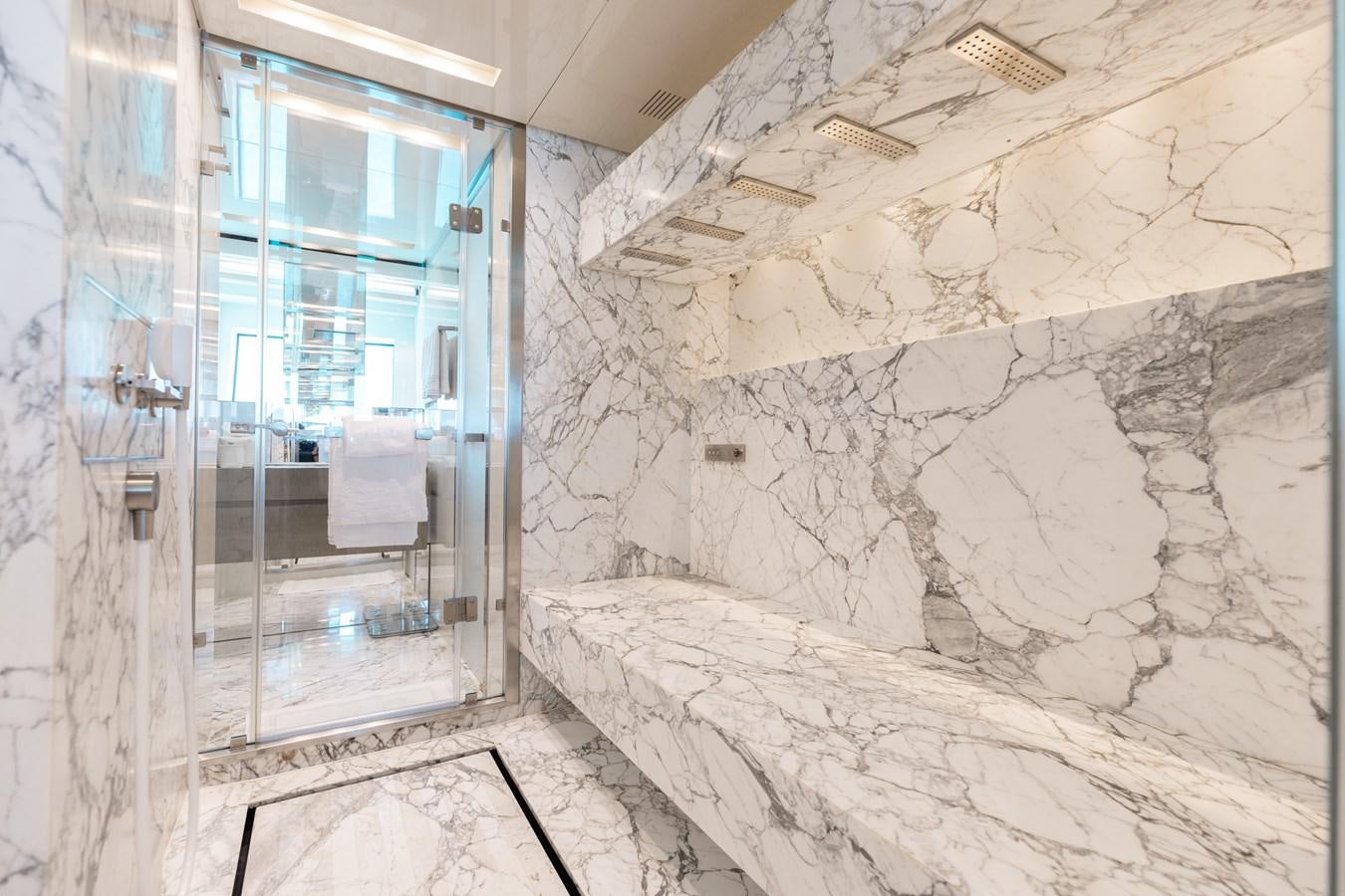 a room with a bed and a glass door aboard TAKARA ONE Yacht for Sale