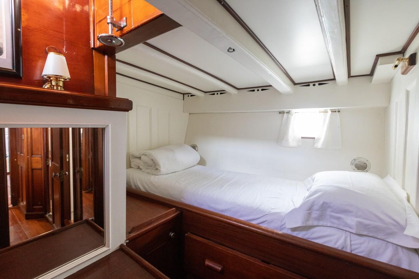 a bed with white sheets aboard MILENA Yacht for Sale
