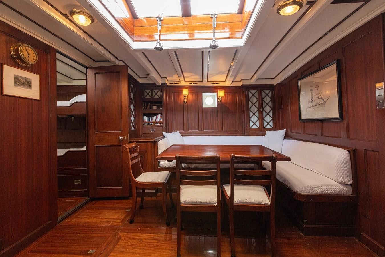 a room with a couch and a table and chairs aboard MILENA Yacht for Sale