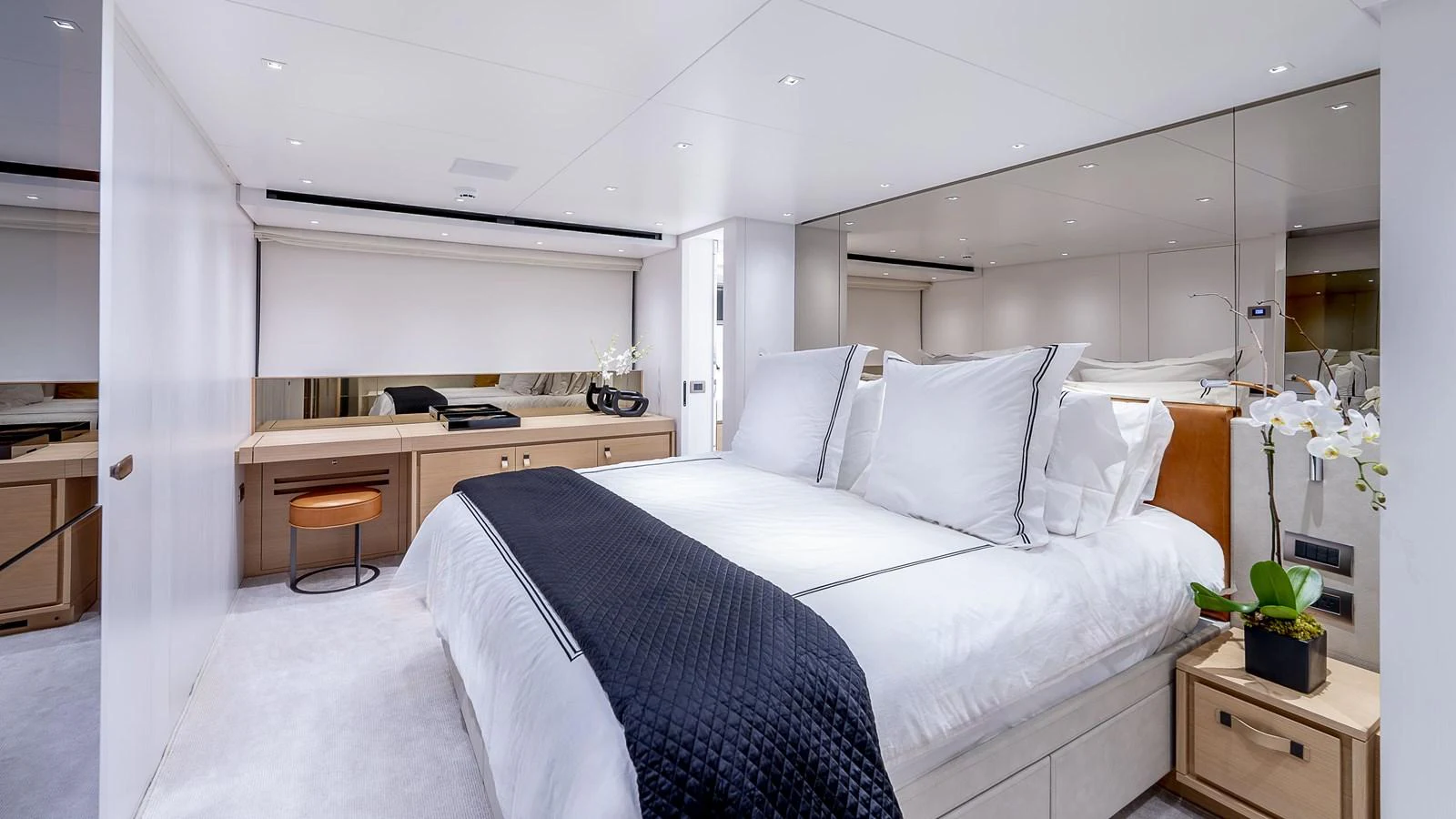 a bedroom with a bed and desk aboard GATSBY Yacht for Sale